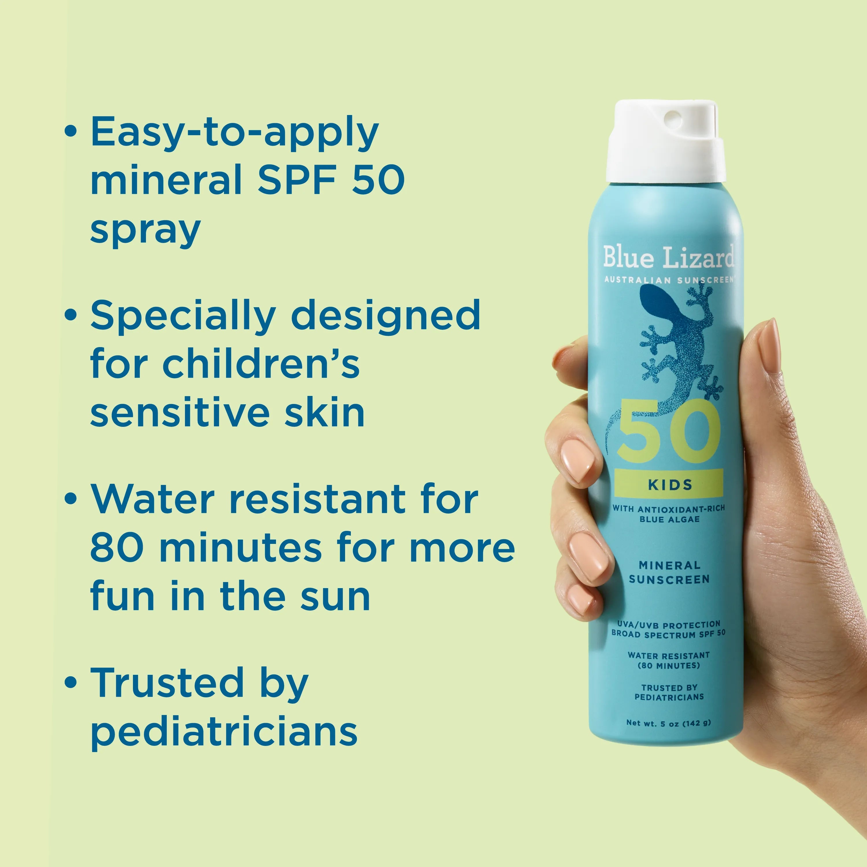 Hand holding Blue Lizard Kids SPF 50 mineral sunscreen spray with product details on a light green background