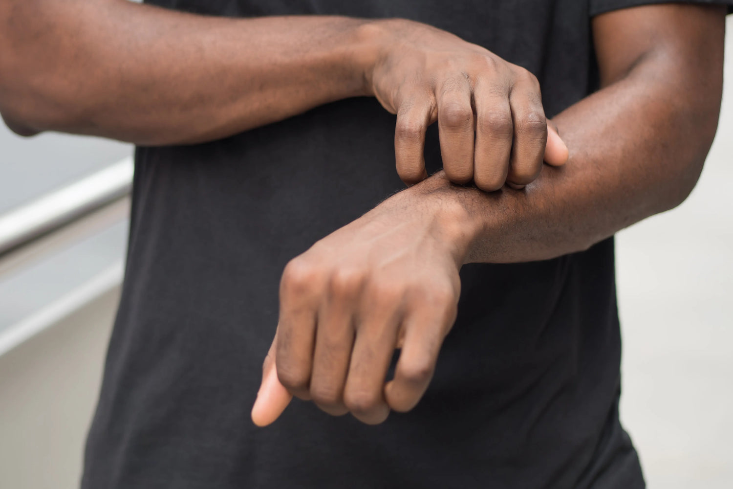 Person scratching their wrist