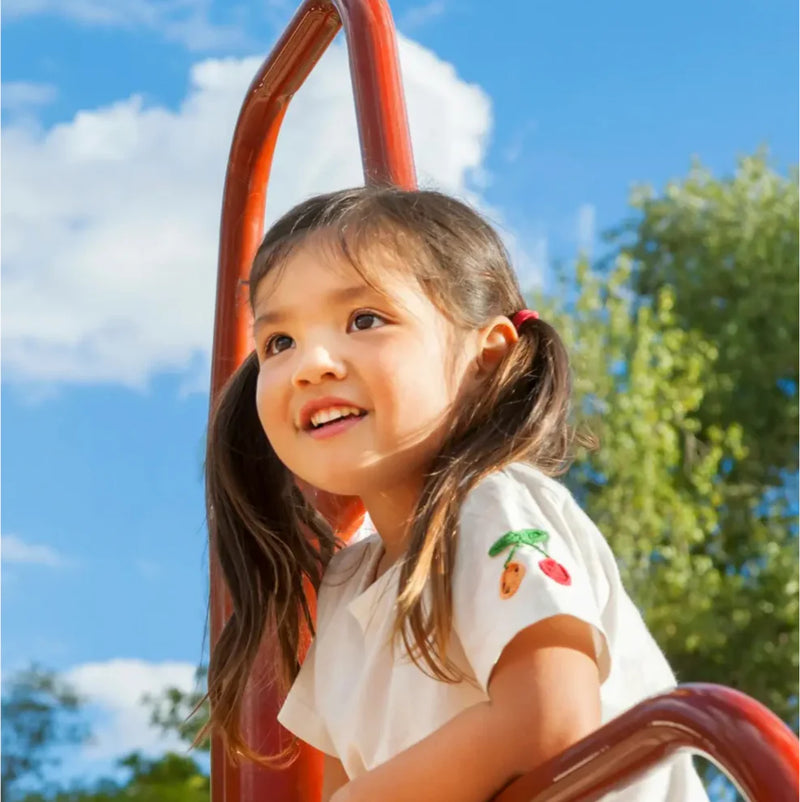 Smiling child on a playground closeup