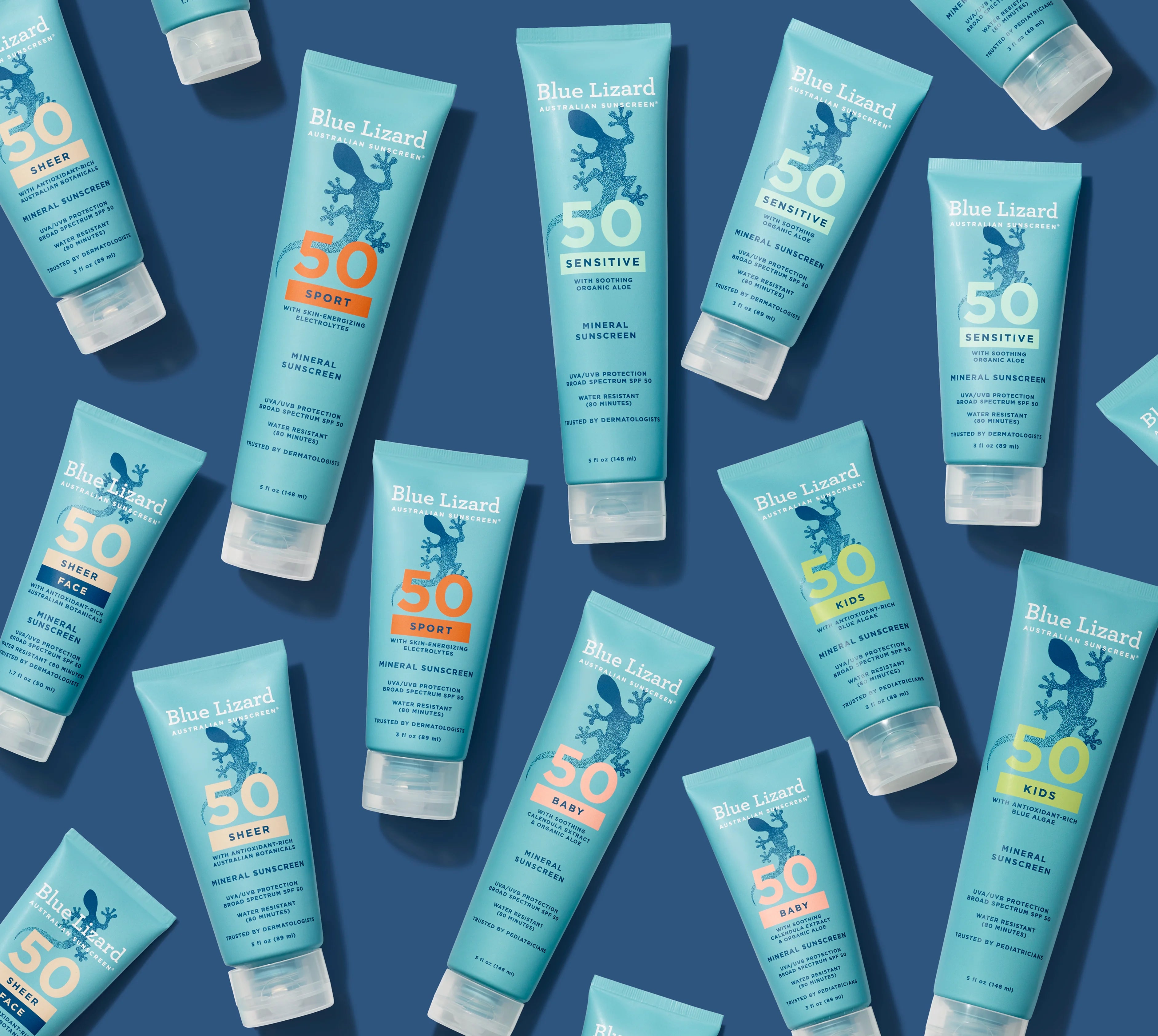 Multiple Blue Lizard sunscreen bottles arranged on a blue background