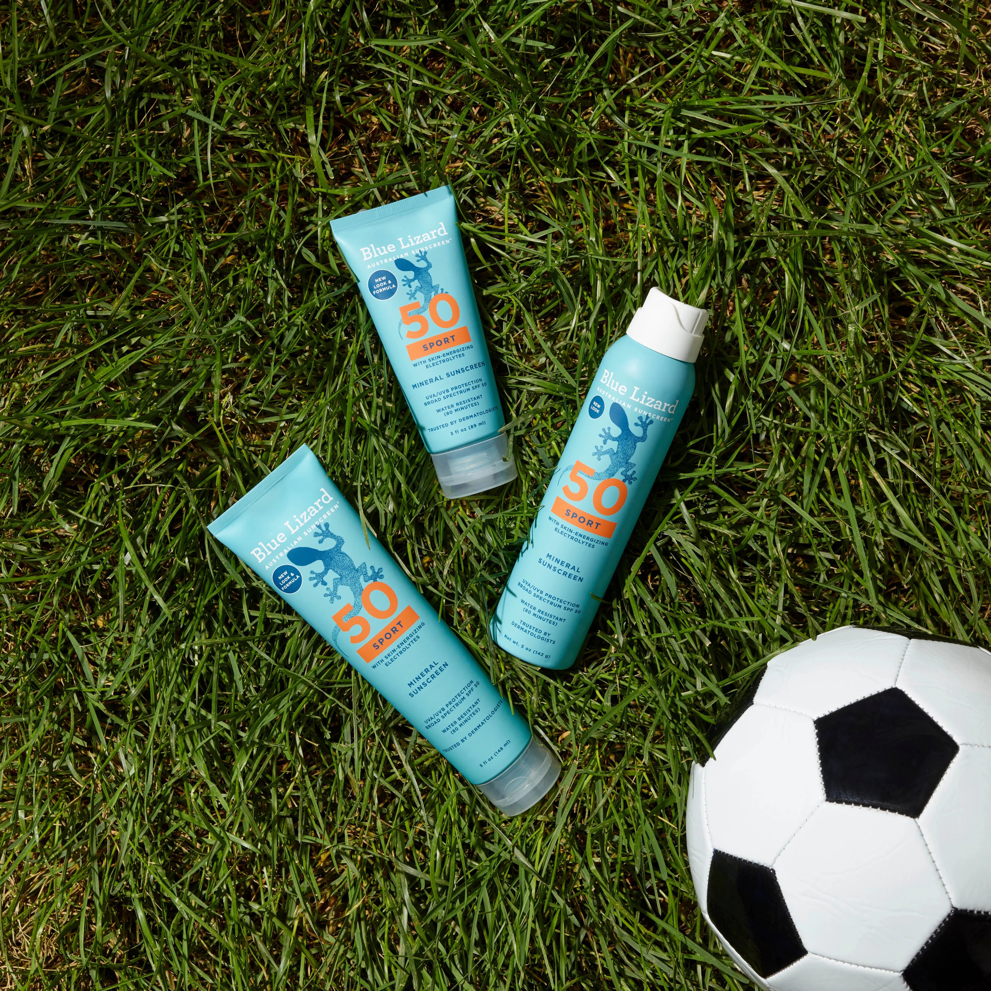 Blue Lizard mineral sunscreen SPF 50 sport collection on a lawn with a soccer ball