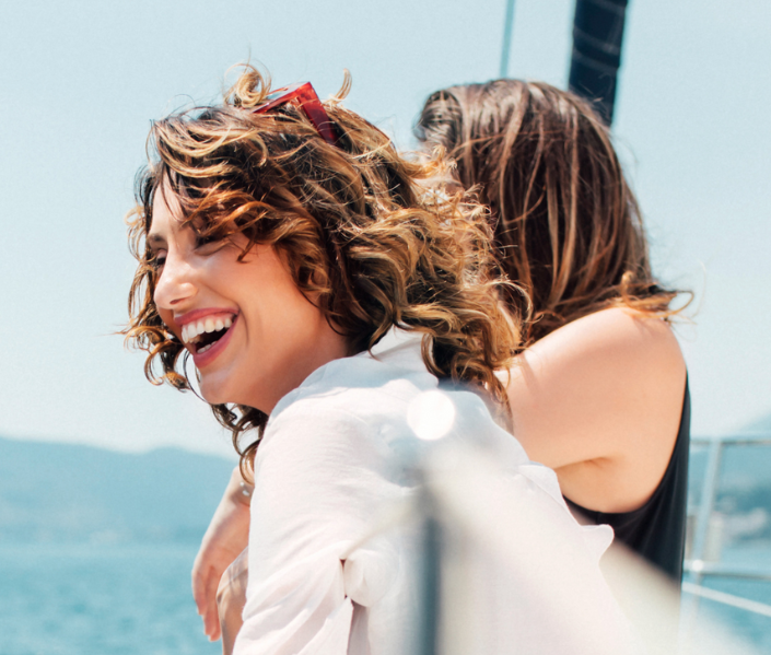 Two women on a boat smiling