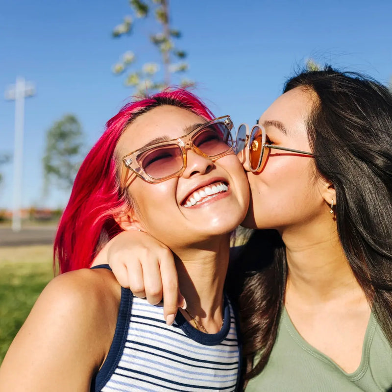 Two women in sunglasses smiling