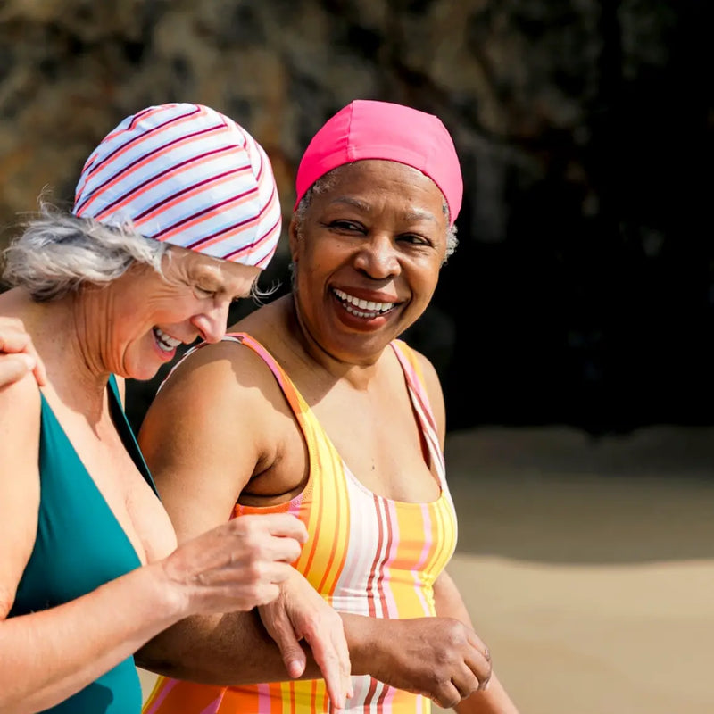 Two women in bathing suits smiling