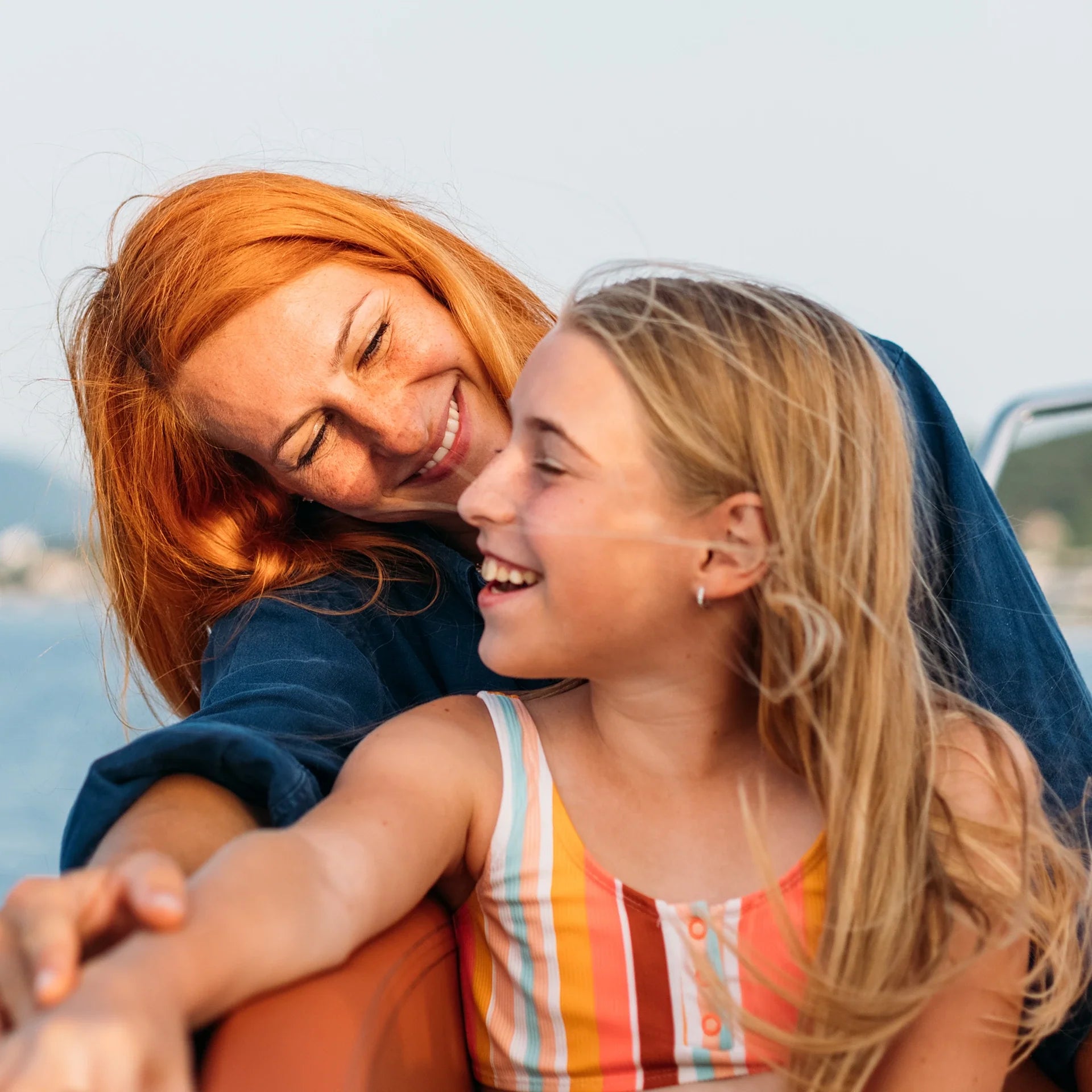 A woman and a child smiling at each other