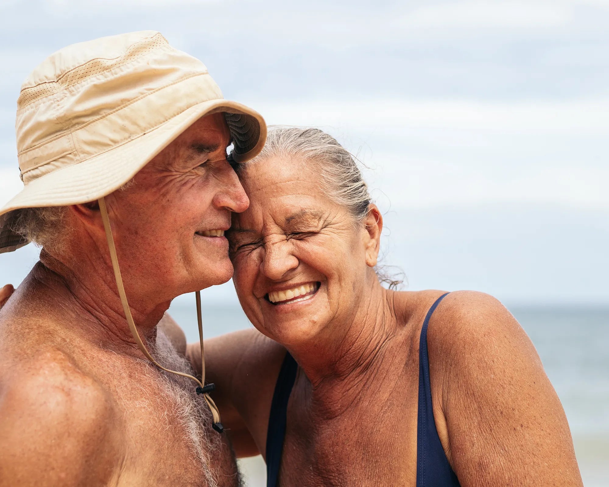 A couple smiling on a beach